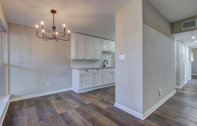 interior space with sink, a chandelier, and dark hardwood / wood-style flooring