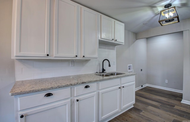 kitchen with sink, white cabinetry, dark hardwood / wood-style floors, and tasteful backsplash