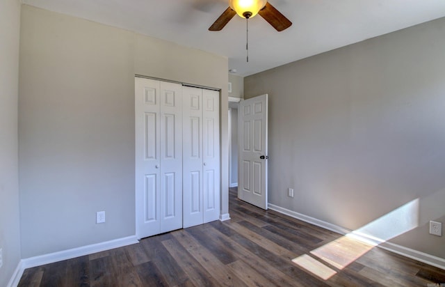 unfurnished bedroom with a closet, dark hardwood / wood-style floors, and ceiling fan