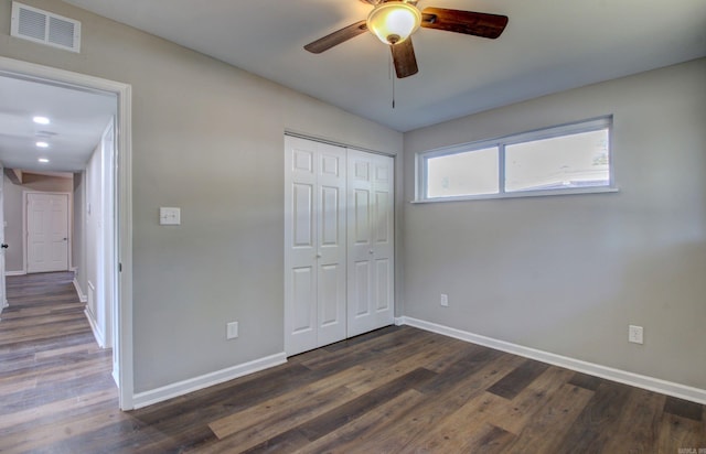 unfurnished bedroom featuring a closet, ceiling fan, and dark hardwood / wood-style flooring