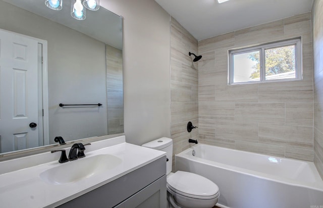 full bathroom with vanity, toilet, and tiled shower / bath combo