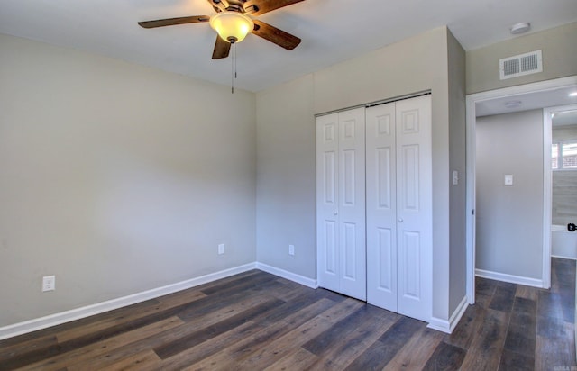 unfurnished bedroom featuring a closet, dark wood-type flooring, and ceiling fan