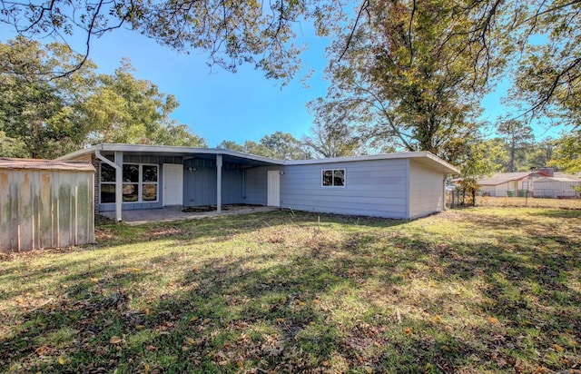 rear view of house featuring a yard