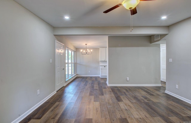 unfurnished living room featuring dark hardwood / wood-style floors and ceiling fan with notable chandelier