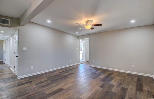 spare room with beamed ceiling, dark hardwood / wood-style floors, and ceiling fan