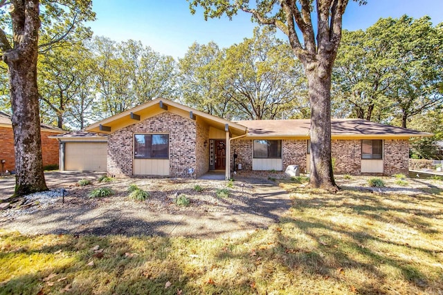 ranch-style home featuring a front yard and a garage