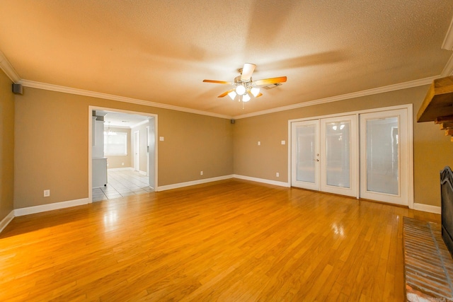 empty room with crown molding, a textured ceiling, light hardwood / wood-style floors, and ceiling fan