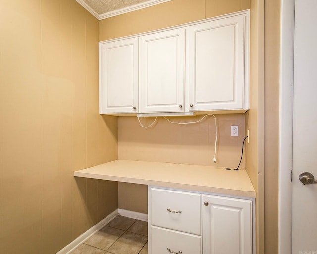 unfurnished office featuring crown molding, a textured ceiling, and light tile patterned floors