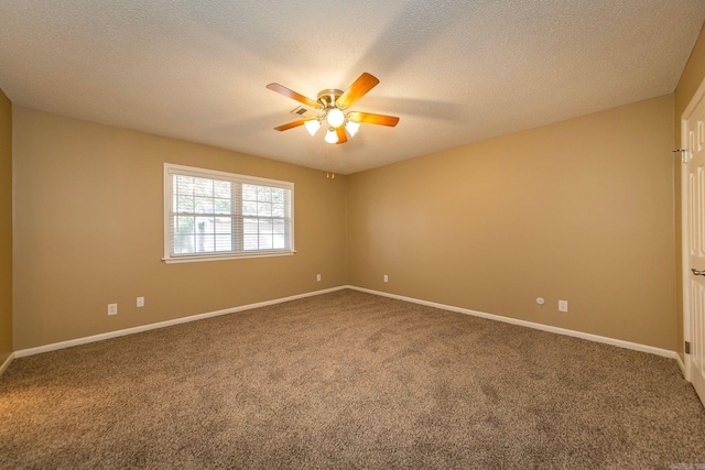 carpeted spare room with a textured ceiling and ceiling fan