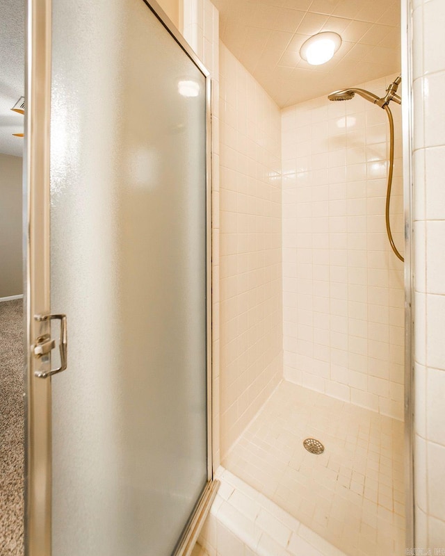 bathroom featuring a shower with door