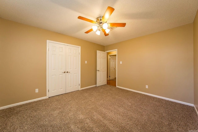 unfurnished bedroom with a closet, a textured ceiling, carpet floors, and ceiling fan