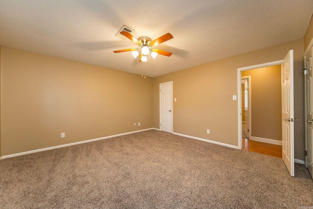 unfurnished bedroom featuring a textured ceiling, carpet flooring, and ceiling fan