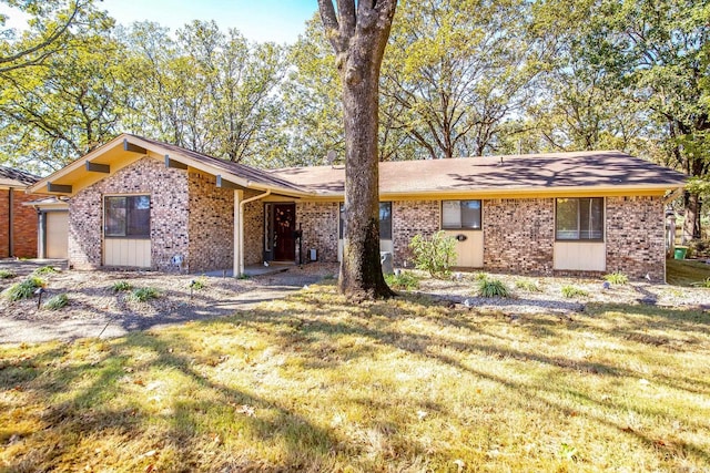 ranch-style home featuring a front yard