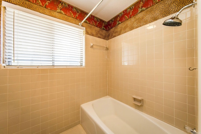 bathroom with tiled shower / bath, a textured ceiling, and plenty of natural light