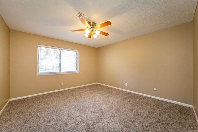 carpeted empty room featuring a textured ceiling and ceiling fan