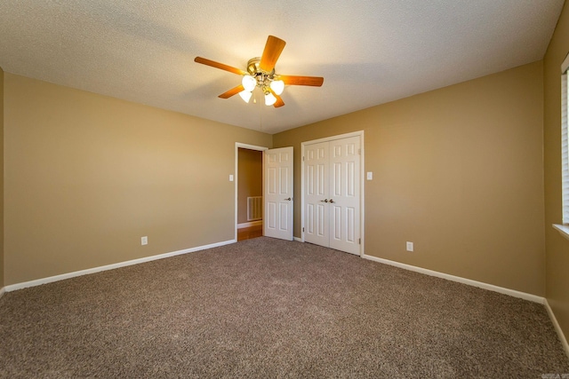 unfurnished bedroom featuring a textured ceiling, carpet flooring, and ceiling fan