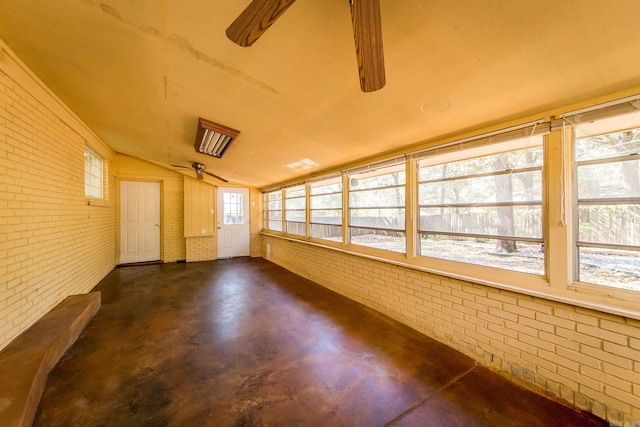 unfurnished sunroom featuring vaulted ceiling and ceiling fan