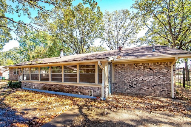 view of side of home with a sunroom