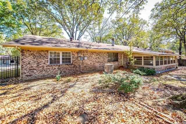 view of front of home with a sunroom and central AC unit