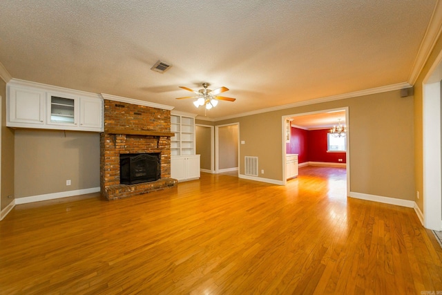 unfurnished living room featuring light hardwood / wood-style flooring, a textured ceiling, ceiling fan with notable chandelier, and a fireplace