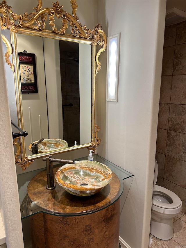 bathroom with vanity, toilet, and tile patterned floors