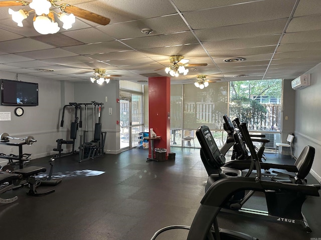 gym featuring a paneled ceiling and ceiling fan