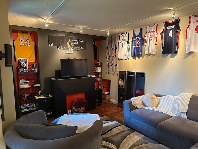 living room with rail lighting, hardwood / wood-style flooring, and a textured ceiling