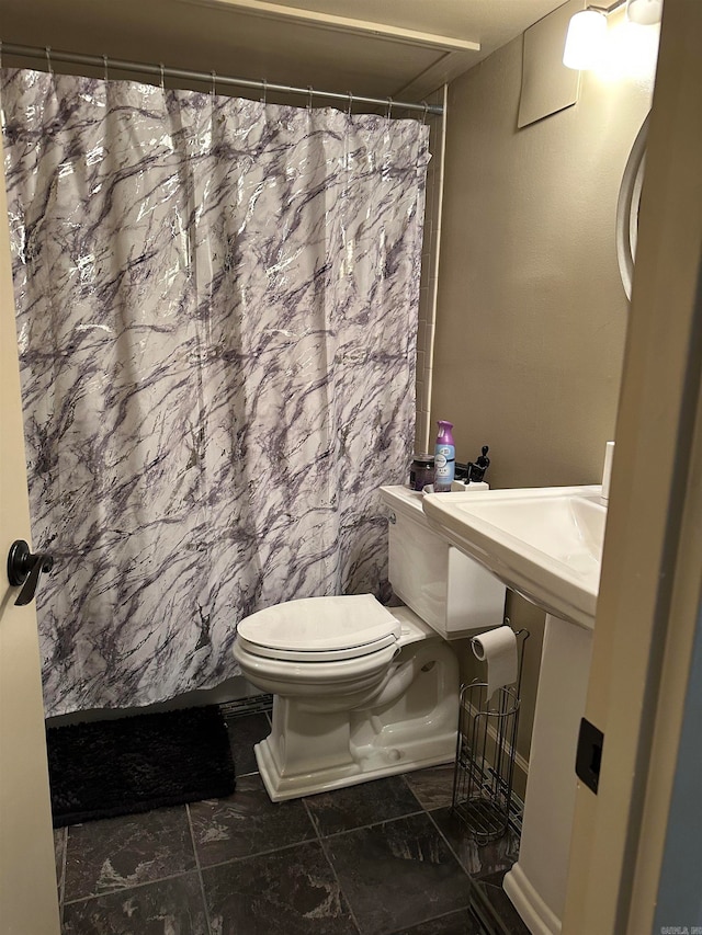 bathroom with toilet, tile walls, and walk in shower