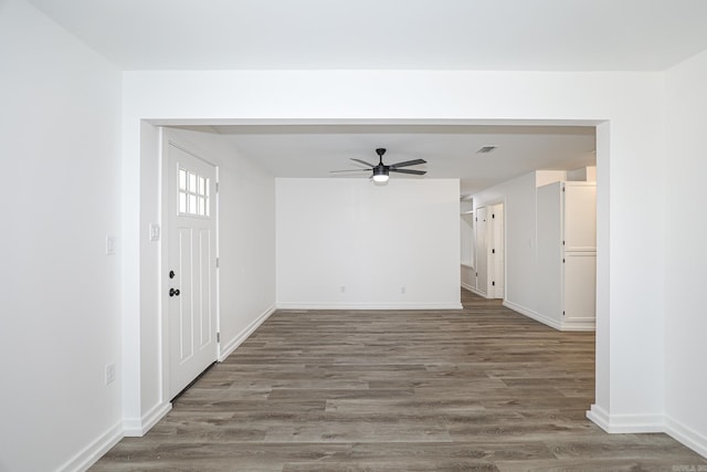 interior space with ceiling fan and dark hardwood / wood-style flooring