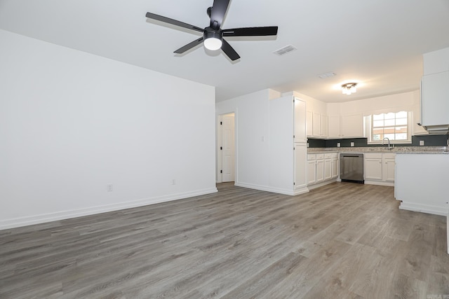 unfurnished living room featuring light hardwood / wood-style floors, sink, and ceiling fan