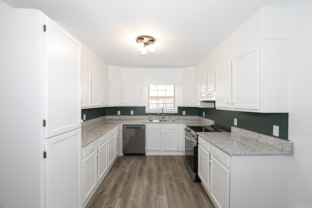 kitchen featuring light stone counters, appliances with stainless steel finishes, white cabinetry, light hardwood / wood-style floors, and sink