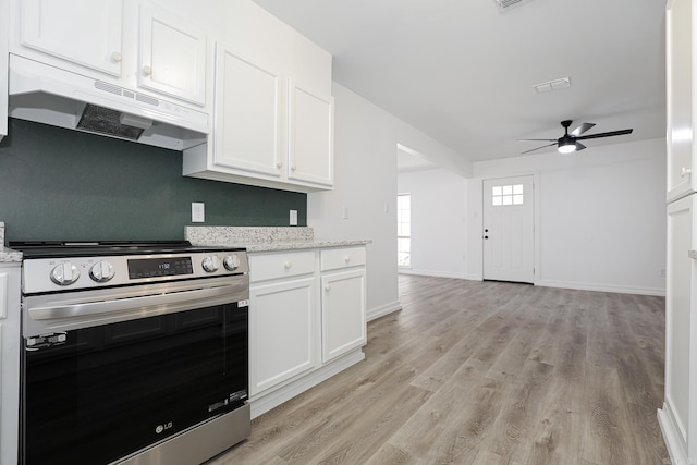 kitchen with ceiling fan, light hardwood / wood-style floors, stainless steel electric range, white cabinets, and light stone counters