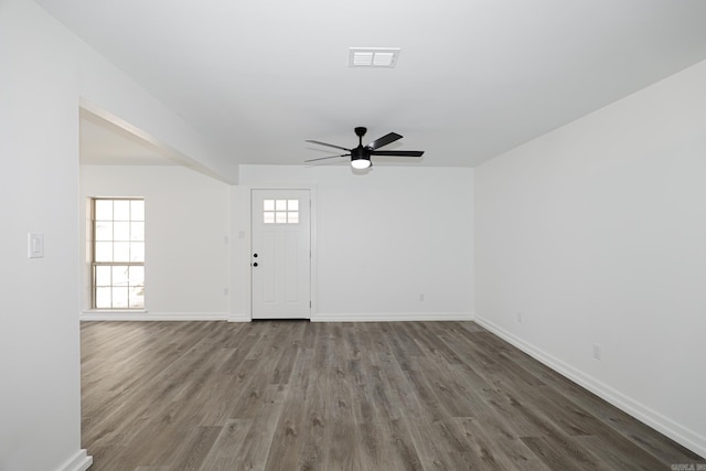 entryway featuring dark wood-type flooring, ceiling fan, and plenty of natural light