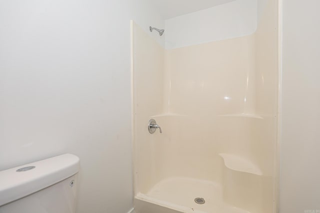 bathroom with toilet and walk in shower