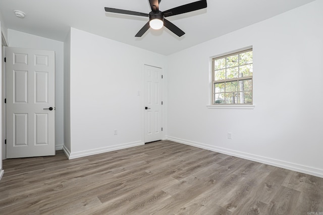 spare room featuring light hardwood / wood-style floors and ceiling fan