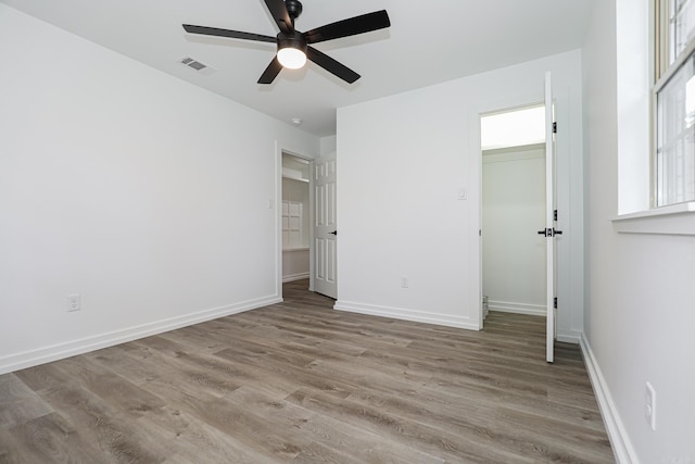 unfurnished bedroom with light wood-type flooring and ceiling fan