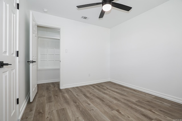 unfurnished bedroom featuring a closet, light hardwood / wood-style floors, and ceiling fan