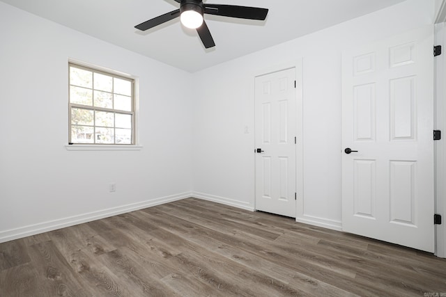 unfurnished bedroom featuring hardwood / wood-style floors and ceiling fan