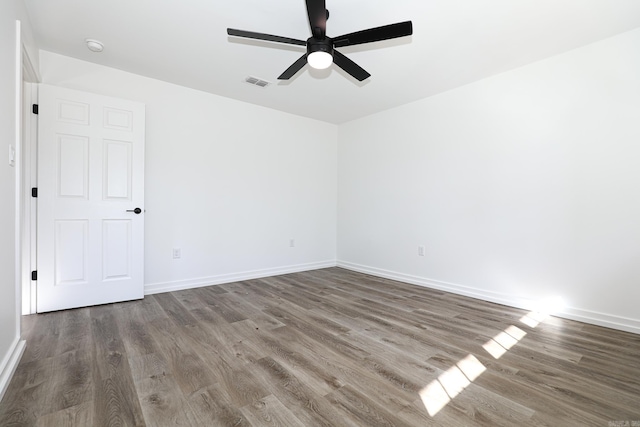 unfurnished room featuring ceiling fan and dark hardwood / wood-style floors