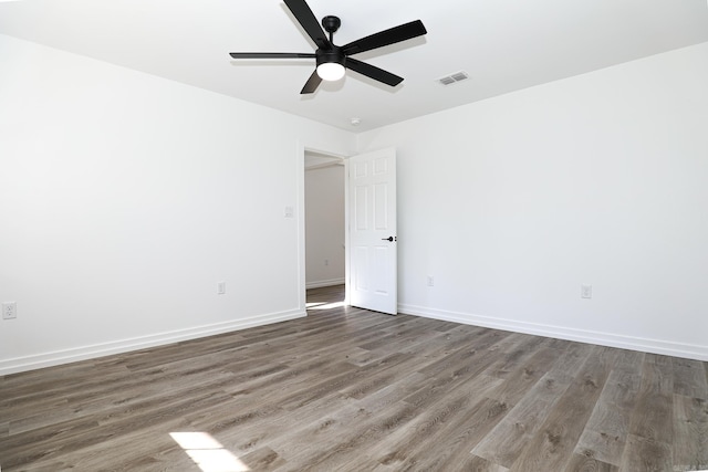 unfurnished room with dark wood-type flooring and ceiling fan