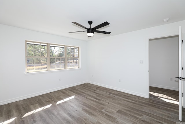 spare room featuring ceiling fan and dark hardwood / wood-style flooring