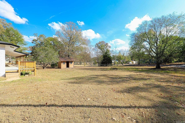 view of yard featuring a storage shed and a deck