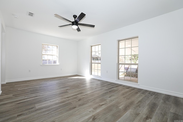 spare room featuring ceiling fan and dark hardwood / wood-style flooring