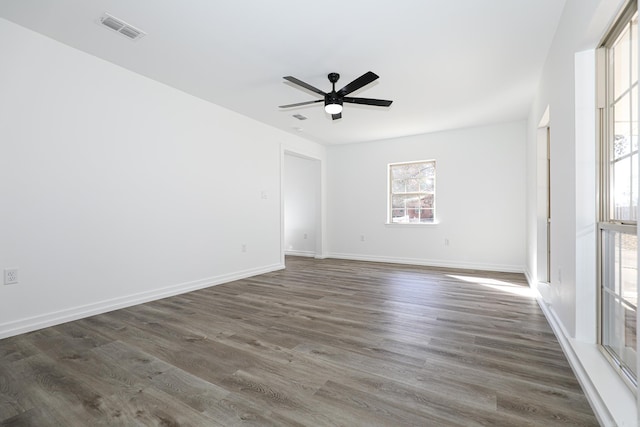 spare room with dark wood-type flooring and ceiling fan