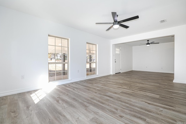 empty room featuring hardwood / wood-style flooring and ceiling fan