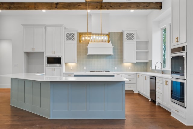 kitchen with white cabinetry, pendant lighting, a center island, and stainless steel appliances