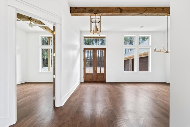 foyer with beam ceiling, a healthy amount of sunlight, and an inviting chandelier