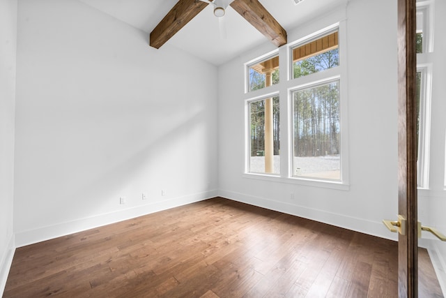 unfurnished room with ceiling fan, dark hardwood / wood-style floors, and beam ceiling