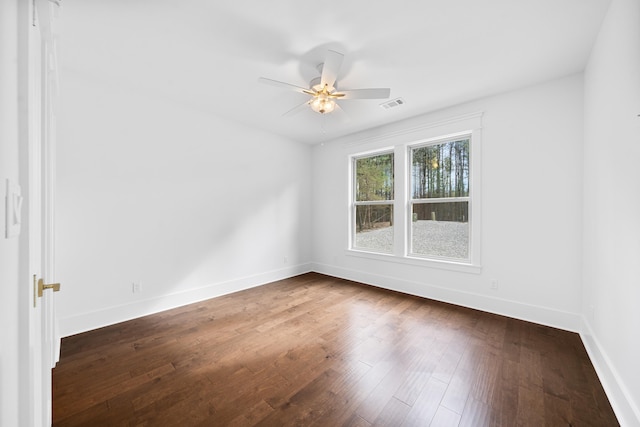 spare room with ceiling fan and dark hardwood / wood-style floors