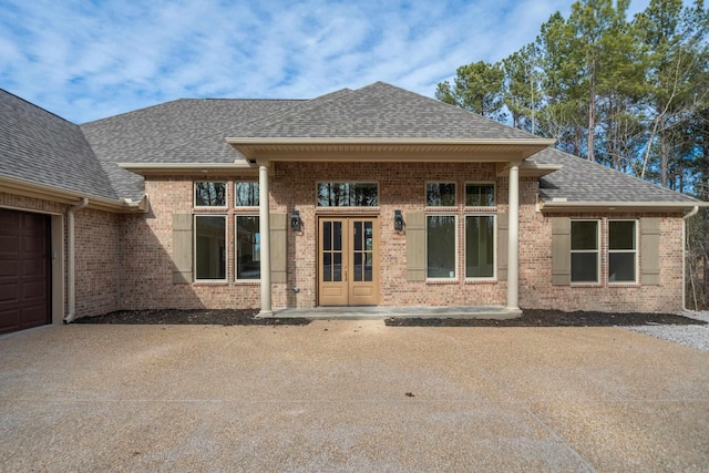 exterior space with french doors and a garage